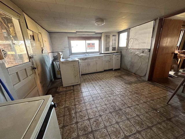 kitchen featuring white cabinetry and range