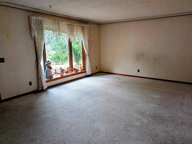 carpeted spare room with a textured ceiling