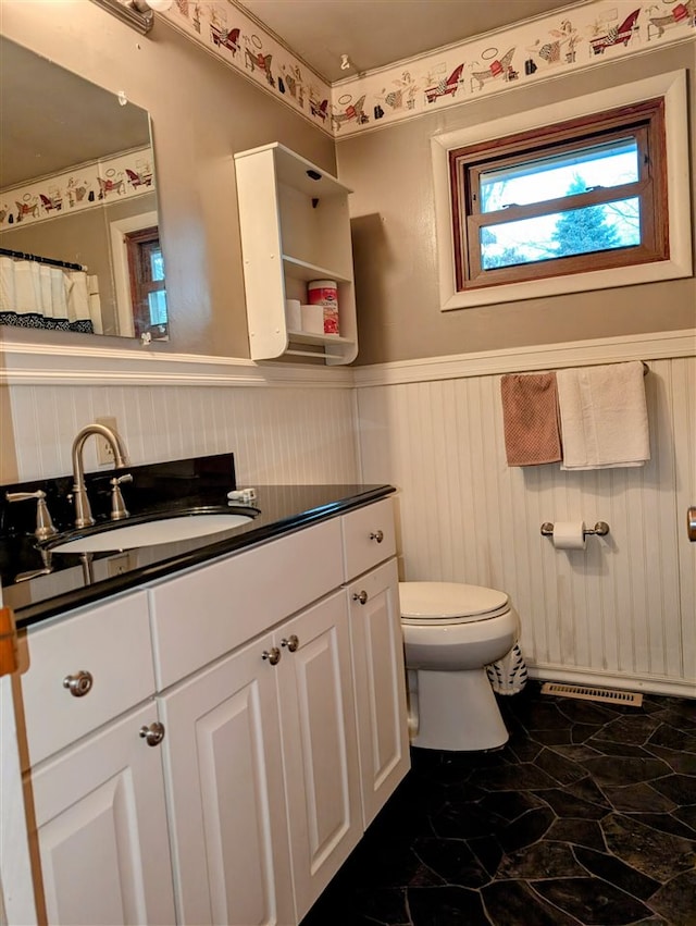 bathroom featuring vanity and toilet