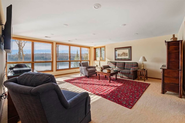 carpeted living room featuring a water view