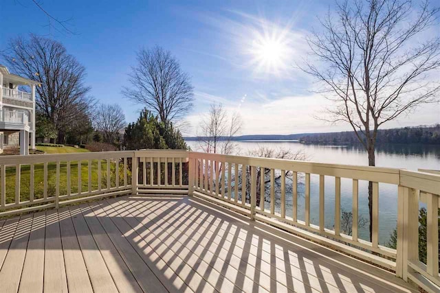 wooden terrace featuring a water view