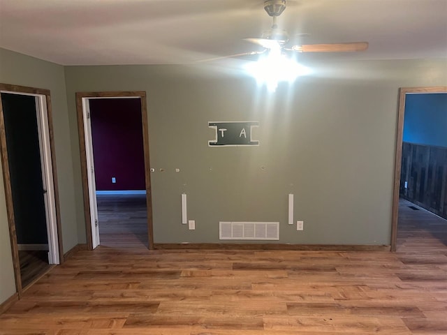 spare room with light hardwood / wood-style floors and ceiling fan