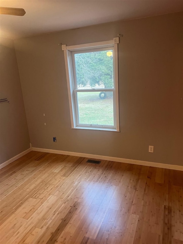 spare room featuring light wood-type flooring