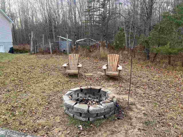 view of yard with an outdoor fire pit