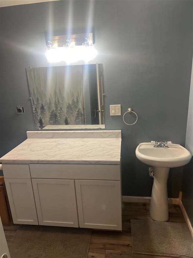 bathroom with hardwood / wood-style flooring