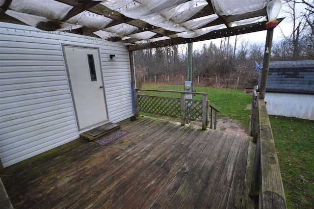 wooden deck featuring an outbuilding and a yard