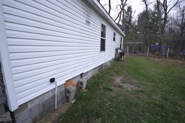 view of side of home featuring a lawn