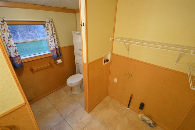 bathroom with tile patterned floors, a textured ceiling, and toilet