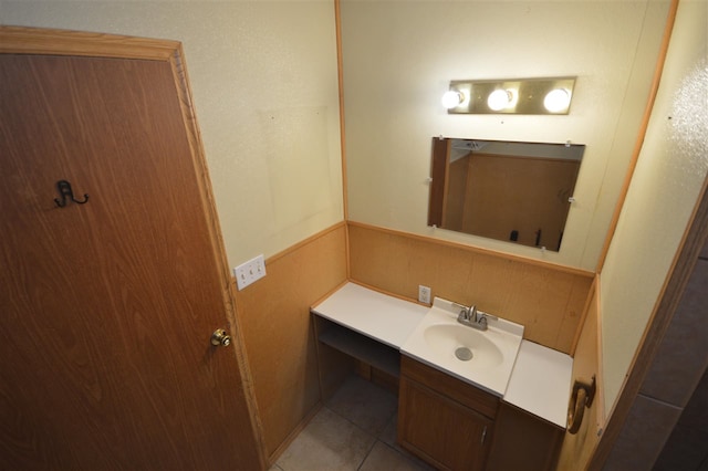 bathroom featuring tile patterned flooring, vanity, and backsplash