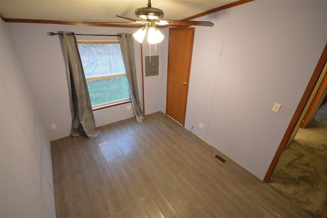 spare room with hardwood / wood-style flooring, ceiling fan, ornamental molding, and a textured ceiling