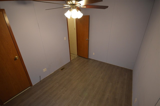 empty room featuring wood-type flooring and ceiling fan