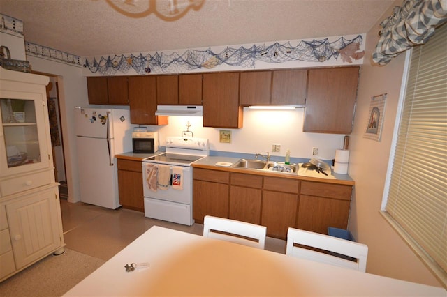 kitchen featuring a textured ceiling, sink, and white appliances