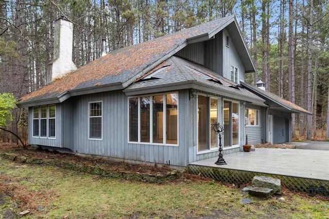 view of side of home featuring a wooden deck