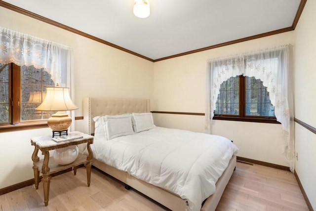 bedroom with light hardwood / wood-style floors and ornamental molding