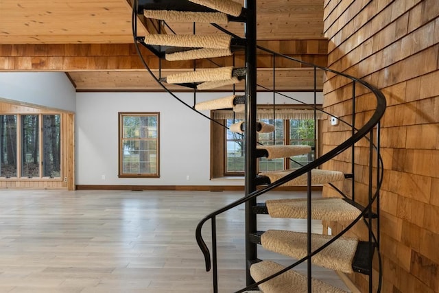 stairway with hardwood / wood-style floors, wood walls, and wooden ceiling