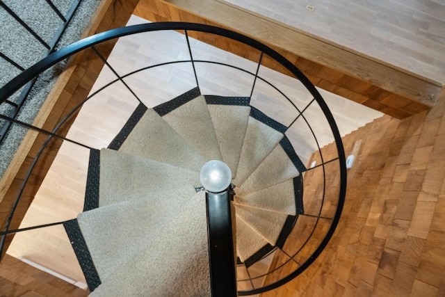 stairs featuring basketball hoop and hardwood / wood-style flooring