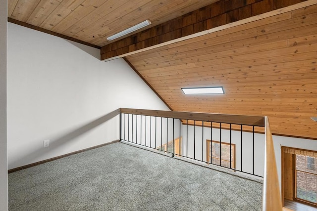additional living space featuring carpet flooring, lofted ceiling with beams, and wooden ceiling