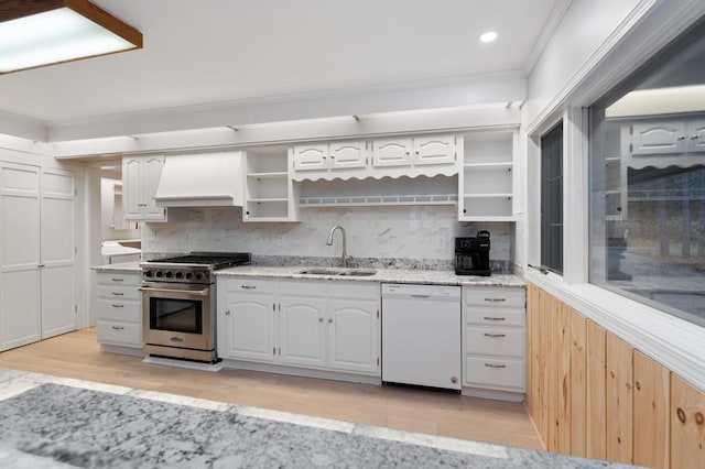 kitchen with dishwasher, premium range hood, sink, stainless steel range, and white cabinetry