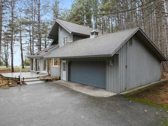 view of side of home featuring a garage