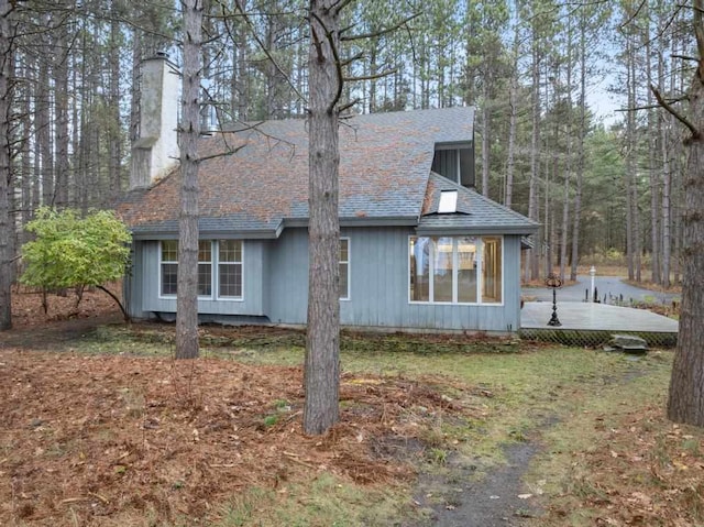 view of property exterior with a wooden deck