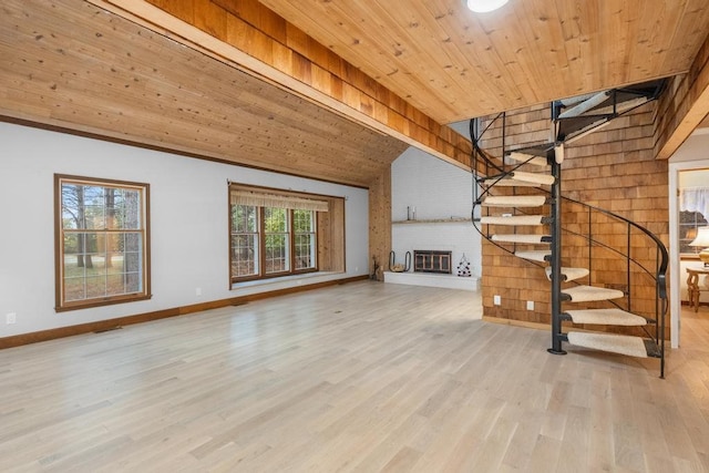 unfurnished living room with a fireplace, vaulted ceiling with beams, light wood-type flooring, and wood ceiling