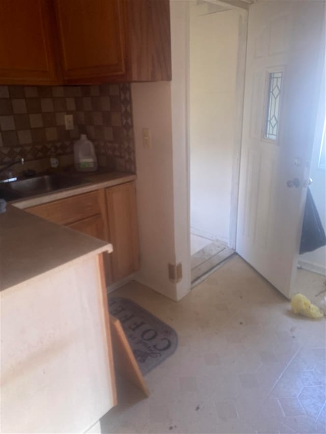 kitchen featuring decorative backsplash and sink