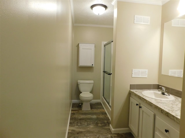 bathroom featuring walk in shower, crown molding, vanity, and hardwood / wood-style flooring