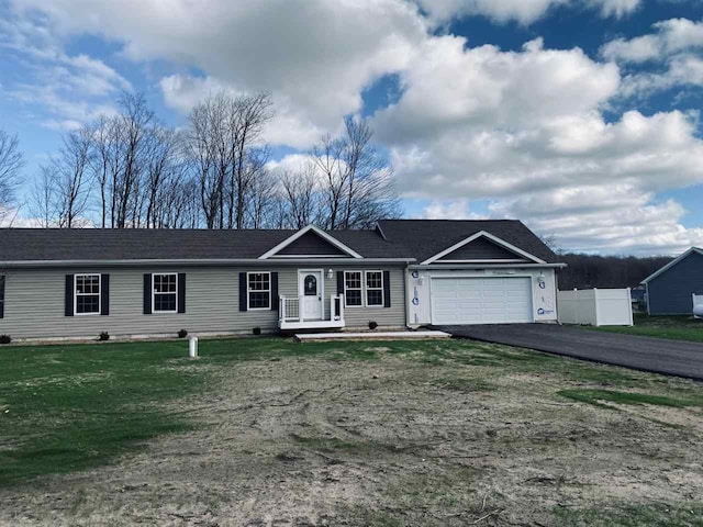 view of front of house with a garage and a front lawn