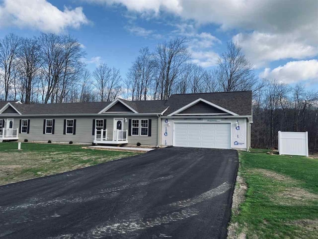 single story home featuring a front yard and a garage