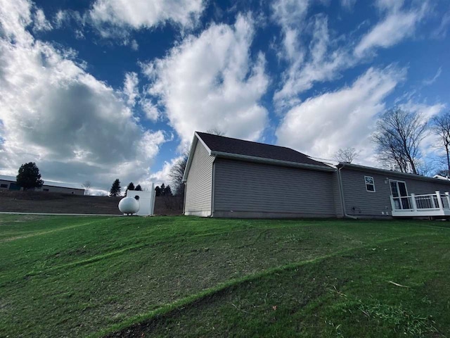 view of home's exterior with a yard and a deck