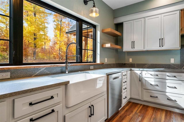 kitchen featuring dark wood-type flooring, white cabinets, and stainless steel dishwasher