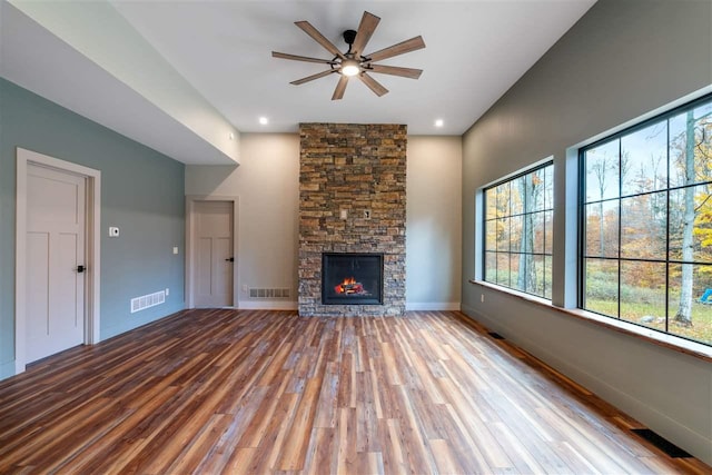 unfurnished living room featuring a fireplace, ceiling fan, and light hardwood / wood-style flooring