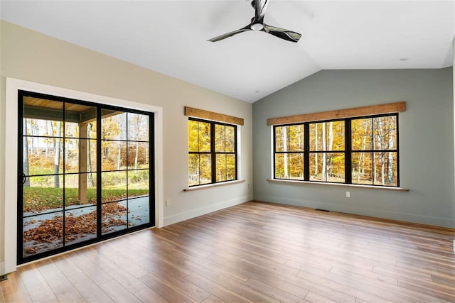 unfurnished room with light wood-type flooring, vaulted ceiling, and ceiling fan