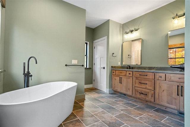 bathroom with a bathtub and vanity