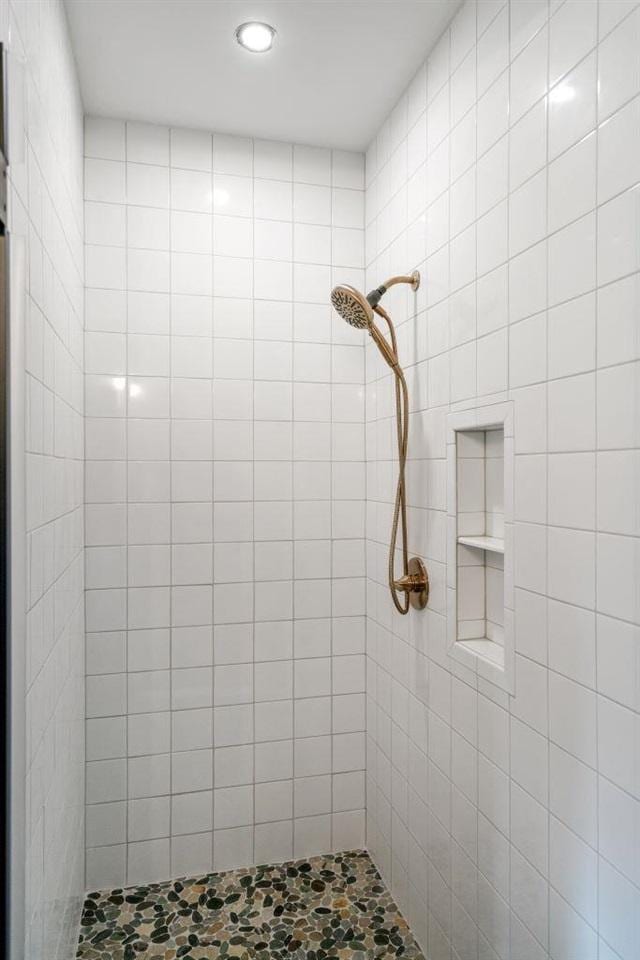 bathroom with a tile shower