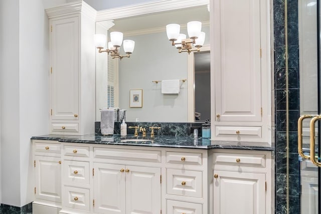 bathroom with vanity, an enclosed shower, and ornamental molding