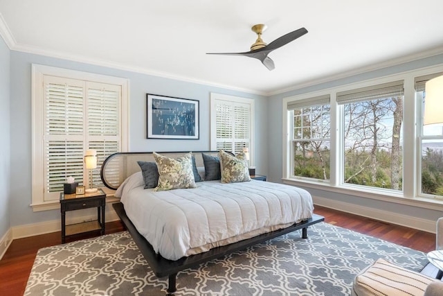 bedroom with dark hardwood / wood-style floors, ceiling fan, and ornamental molding