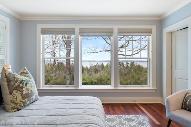 bedroom with dark hardwood / wood-style flooring and ornamental molding