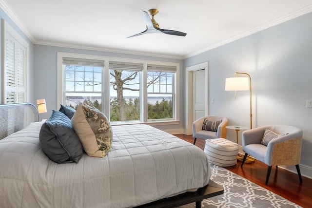 bedroom featuring multiple windows, ornamental molding, ceiling fan, and dark wood-type flooring