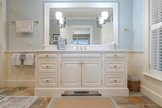 bathroom with crown molding and vanity