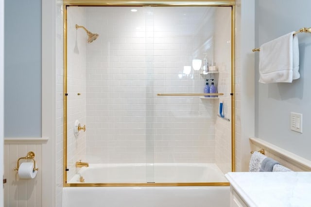 bathroom featuring shower / bath combination with glass door and vanity