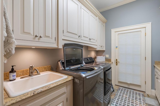 laundry room featuring cabinets, ornamental molding, sink, washer and dryer, and light tile patterned flooring