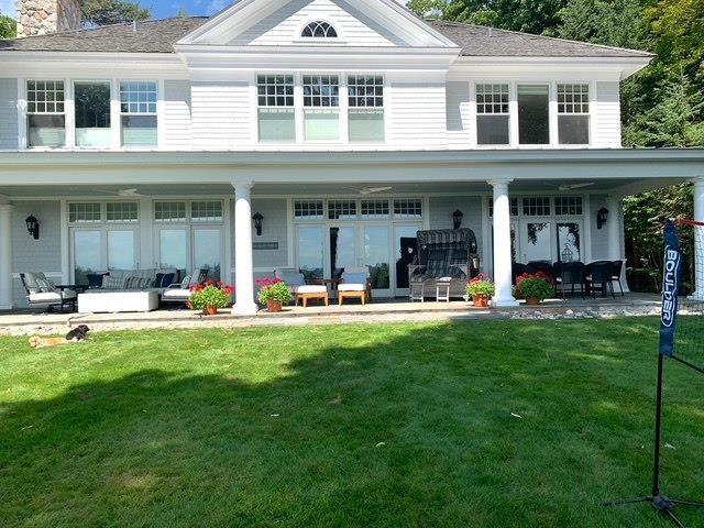 back of house featuring outdoor lounge area, a patio area, and a yard