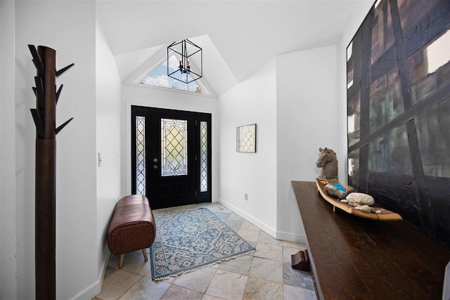 entryway with high vaulted ceiling and a chandelier