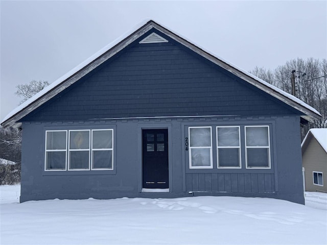 view of snow covered rear of property