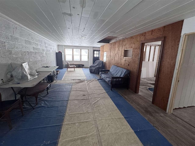 interior space featuring wood-type flooring and wooden walls