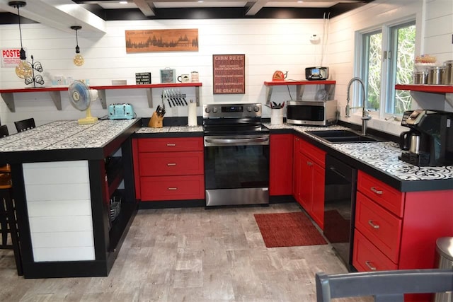 kitchen with sink, hanging light fixtures, light wood-type flooring, appliances with stainless steel finishes, and beam ceiling