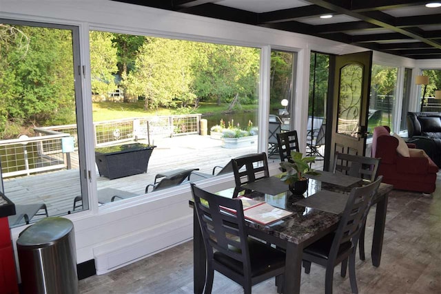 sunroom / solarium with a water view and coffered ceiling