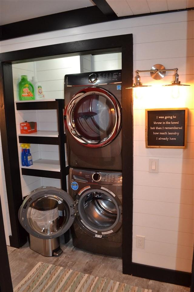 laundry room with stacked washer / dryer