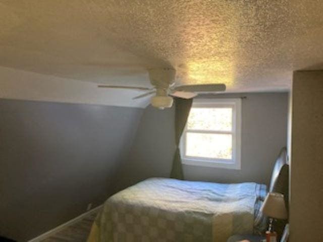 bedroom featuring a textured ceiling and ceiling fan